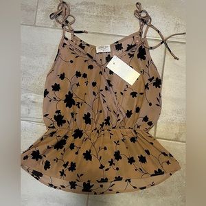 Sleeveless blouse with peplum waist.